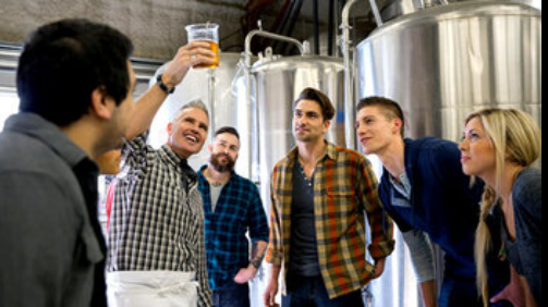 A group tasting at a brewery tank room