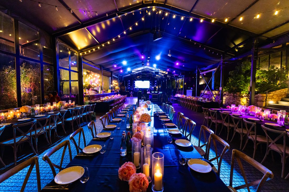 Long tables set for an evening corporate function
