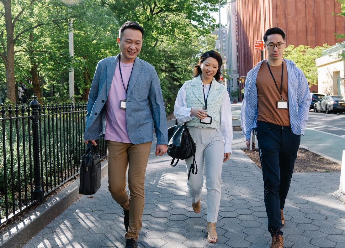 Employees with ID badges walking to the office